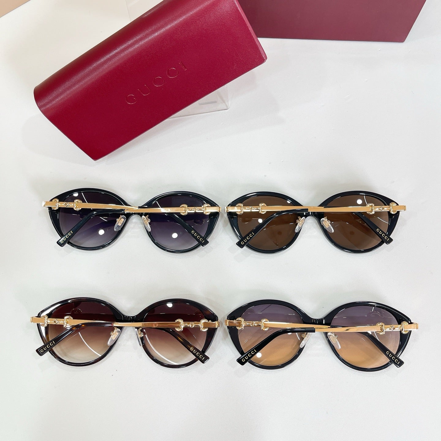 Four round sunglasses with black frames, gold-tone accents, and tinted lenses