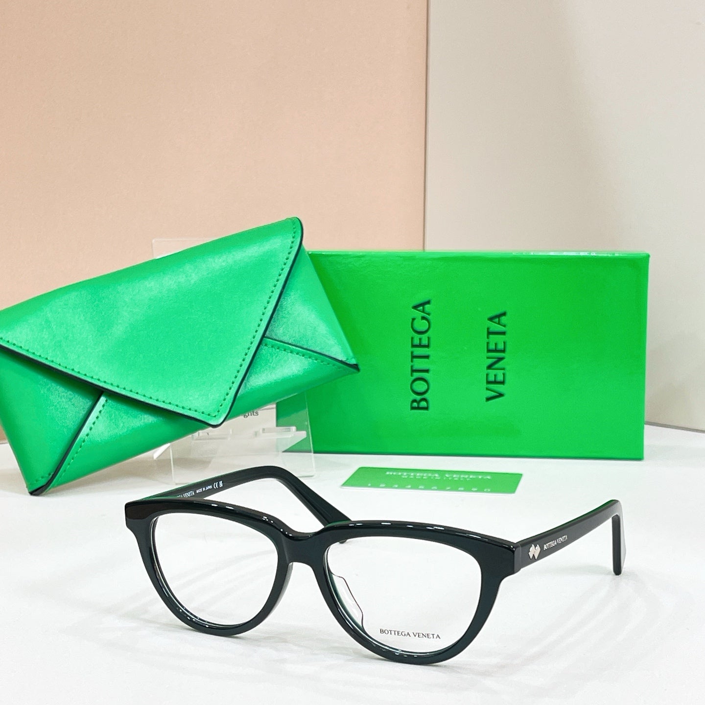 Black rectangular eyeglasses with clear lenses, Bottega Veneta logo on temple arms.