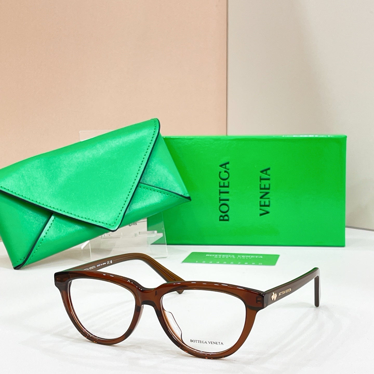 Brown tortoiseshell rectangular eyeglasses with clear lenses, Bottega Veneta logo on temples.