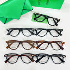 Assorted eyeglasses with clear lenses, featuring black and tortoiseshell frames on cards.