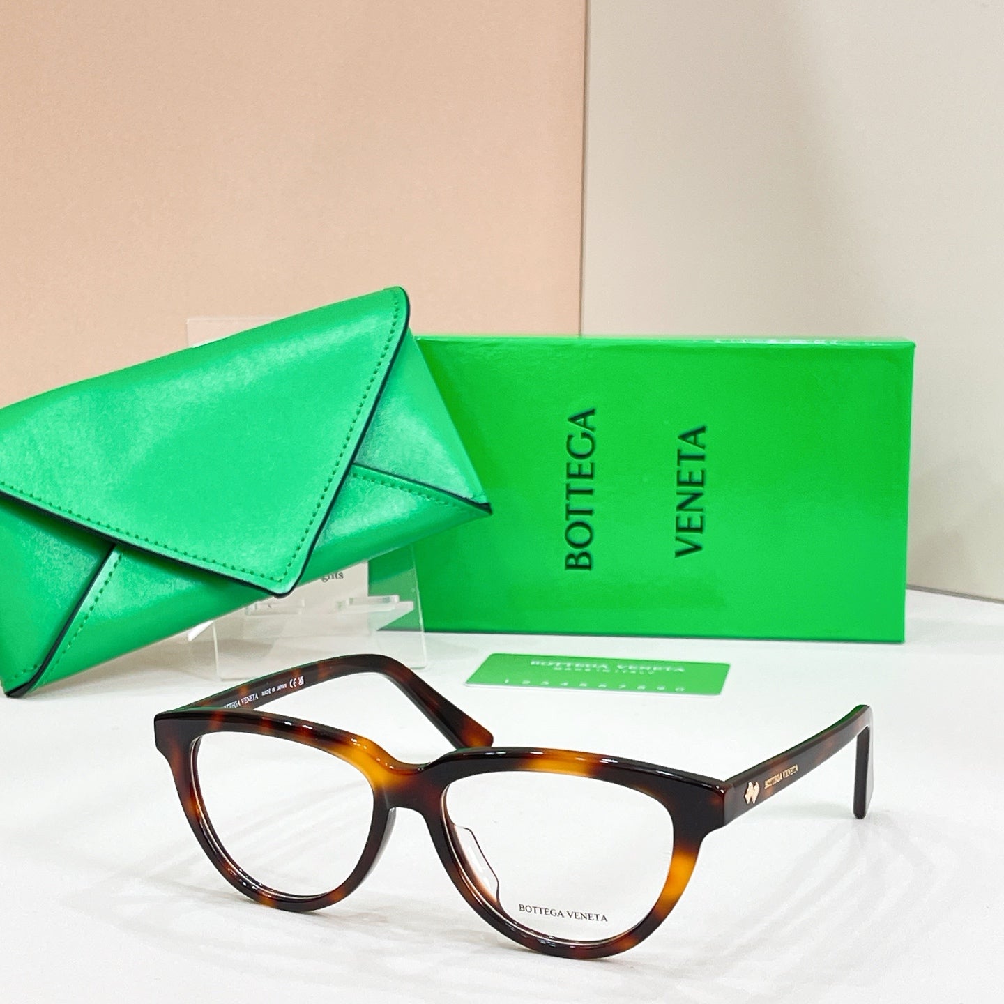 Tortoiseshell rectangular eyeglasses with clear lenses, Bottega Veneta logo on temples.