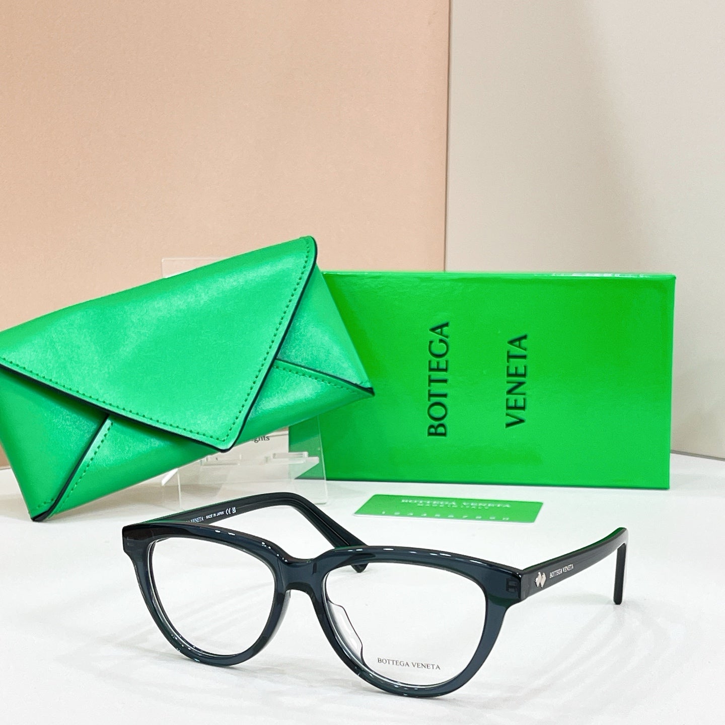 Black rectangular eyeglasses with clear lenses, Bottega Veneta logo on the temple arm.