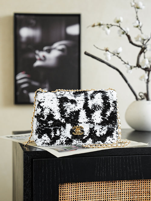 Black-and-white sequin shoulder bag with gold chain and logo clasp