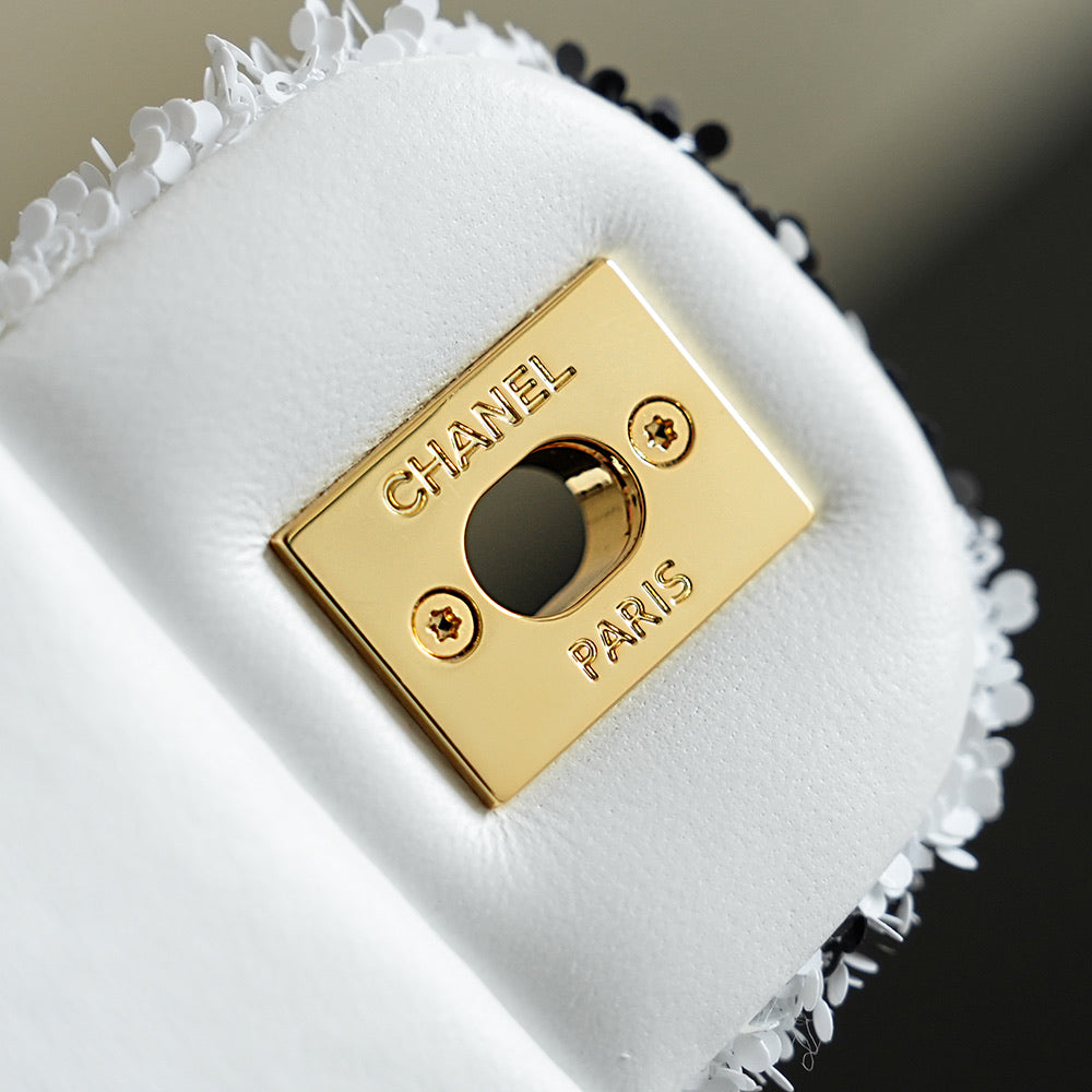 White Chanel flap with gold logo plate and heart-shaped clasp