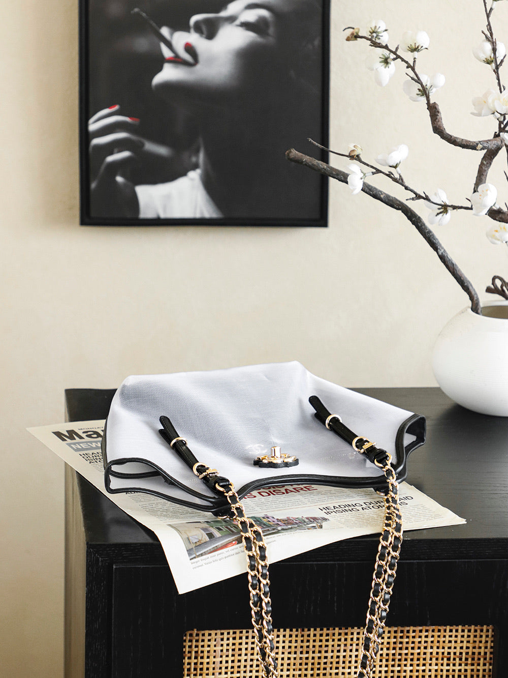 White Chanel tote bag with black trim, gold chain strap, and small gold accents