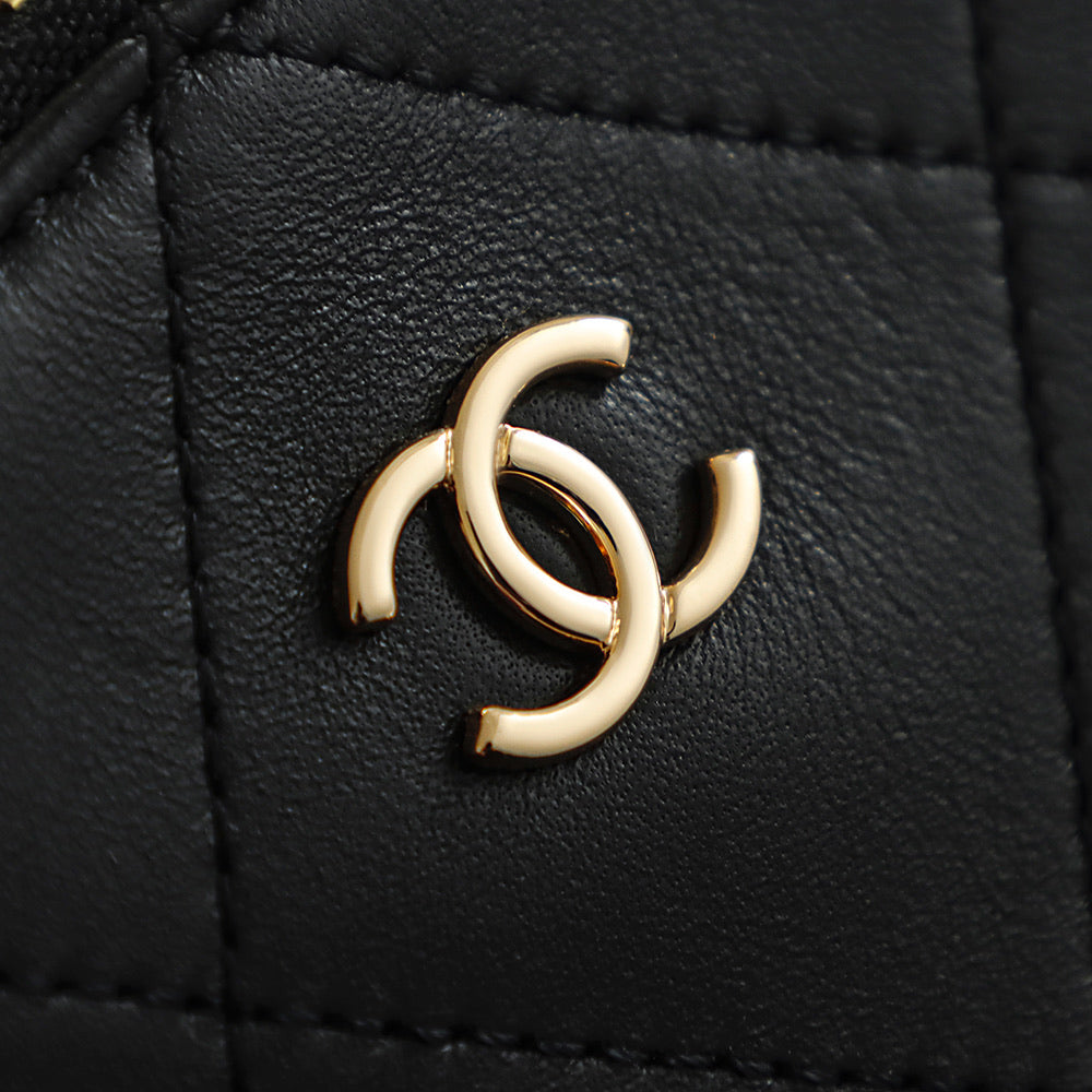 Chanel CC logo hardware on black leather bag panel, close-up