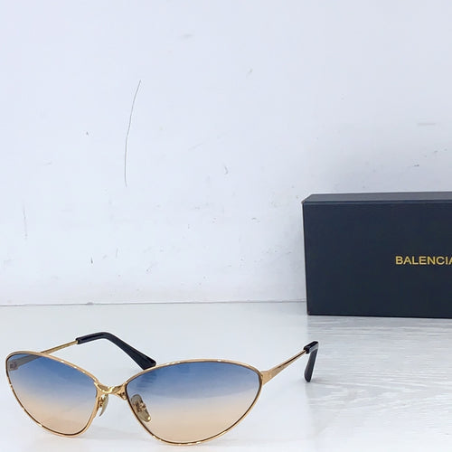 Sunglasses with gold frames and light blue tinted lenses, oval cat-eye style.