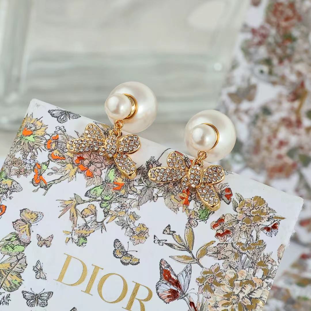 Dior floral bow earrings with gold-tone filigree, crystal detailing, and pearl drops