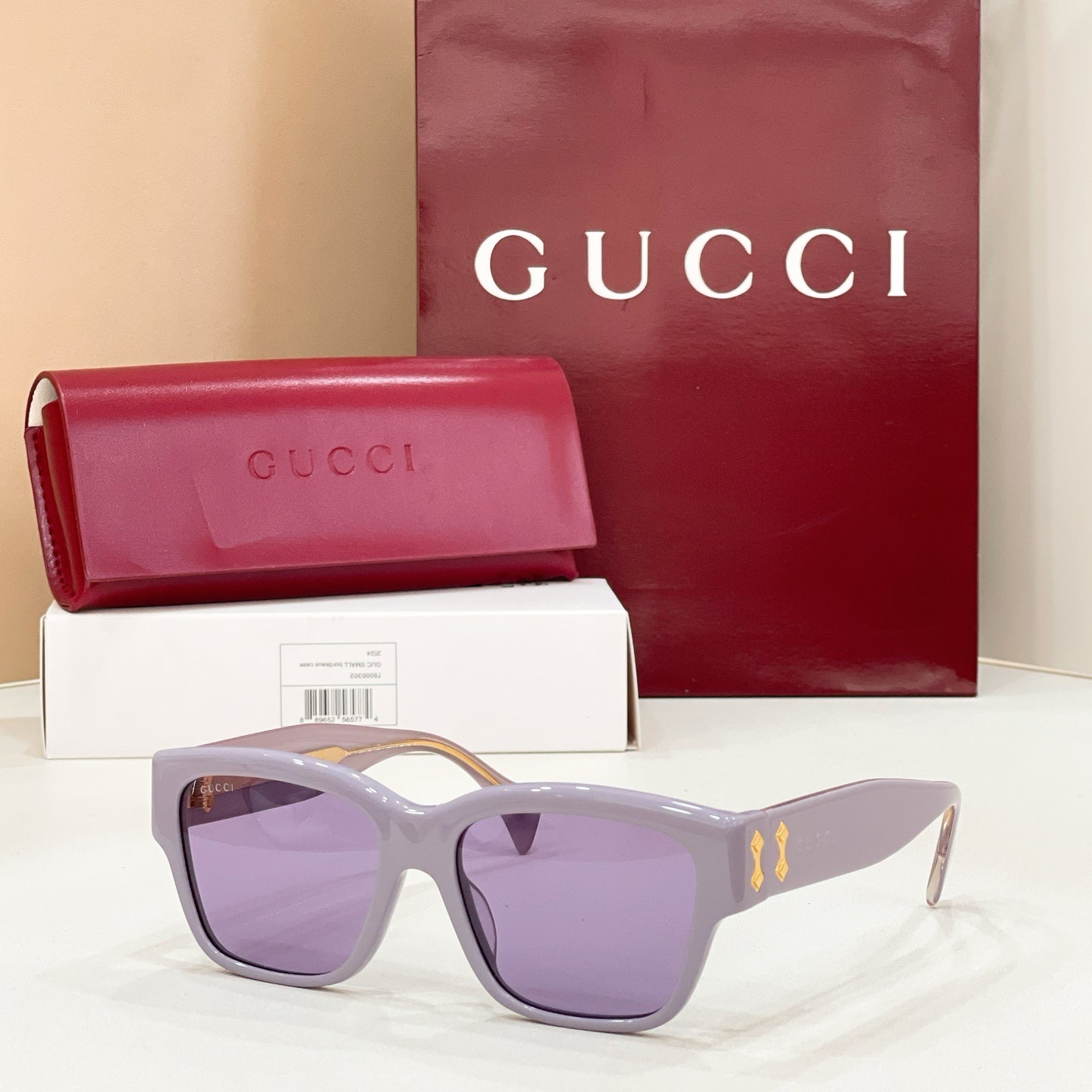 Gucci cat-eye sunglasses with lavender frame and purple-tinted lenses