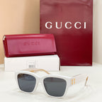 Gucci cat-eye sunglasses with white frame and dark lenses