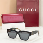 Gucci cat-eye sunglasses with black frame and smoke gray lenses