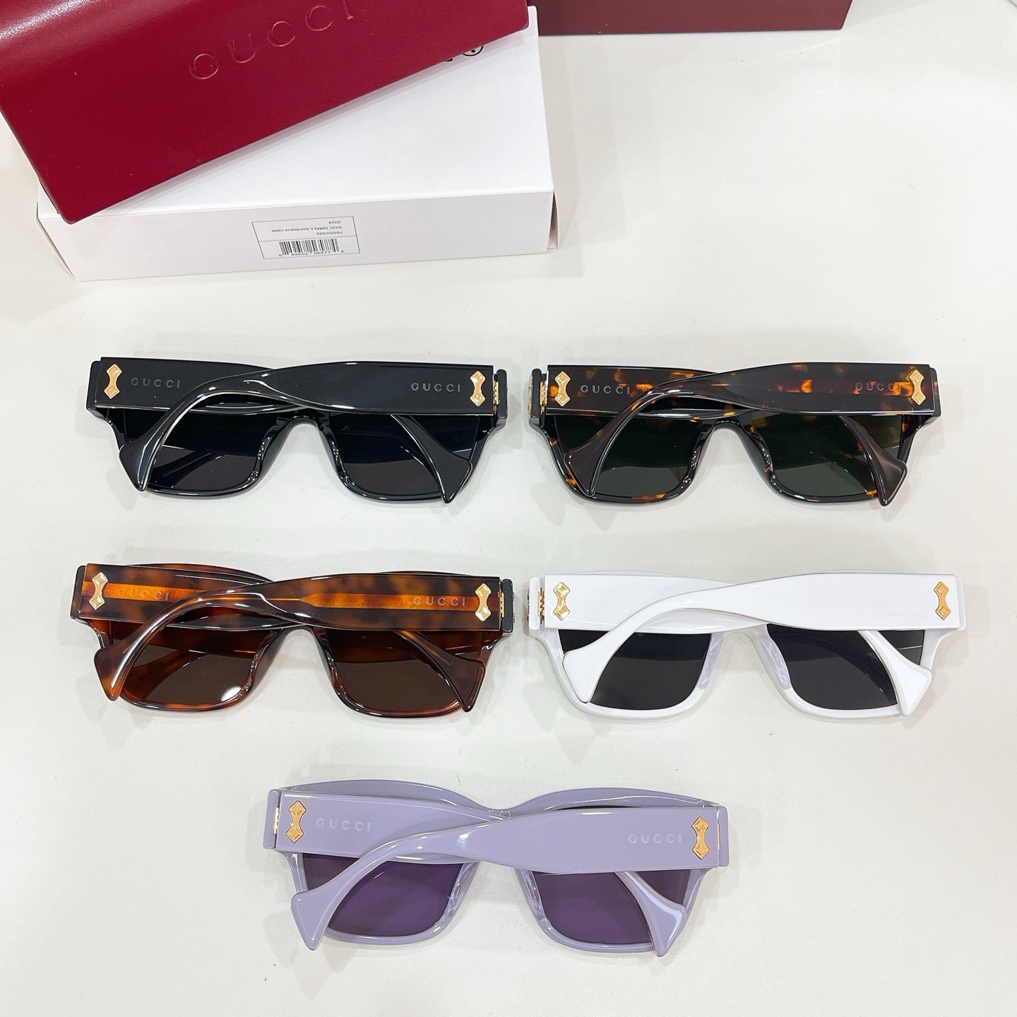 Set of Gucci cat-eye sunglasses: black, tortoiseshell, white, and lavender frames