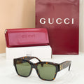 Gucci cat-eye sunglasses with dark tortoiseshell frame and green-tinted lenses