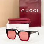 Pink-red square sunglasses with pink tinted lenses, wide frames and gold logo detail