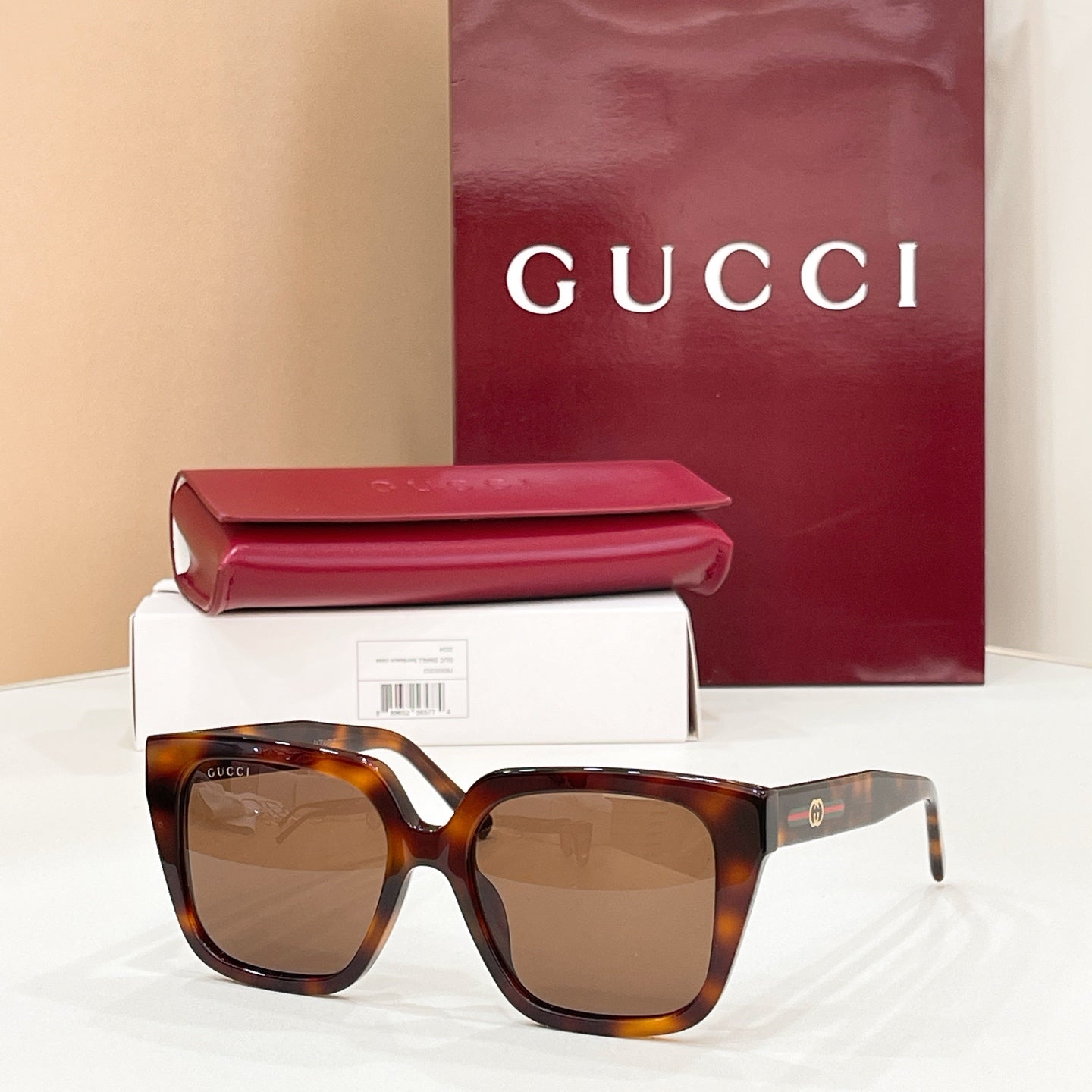 Tortoise brown square sunglasses with brown tinted lenses, wide frames and gold logo tips