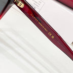Burgundy sunglasses temple arm with gold lettering reading 'Made in Italy'