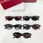 Set of assorted Gucci sunglasses with dark lenses and gold logo details on temples.