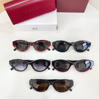Assorted Gucci sunglasses on white surface, black and red frames with dark lenses.
