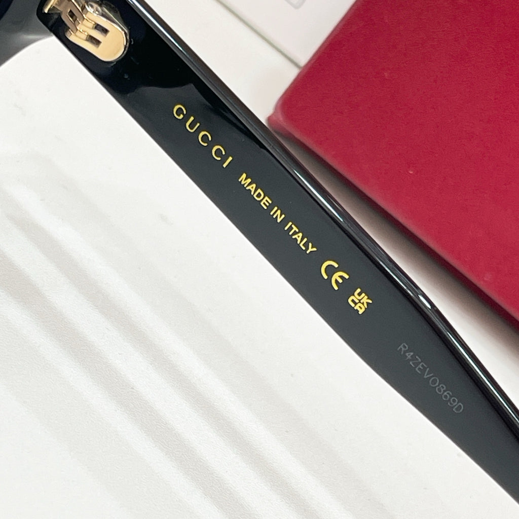 Black sunglasses temple text 'GUCCI MADE IN ITALY' with small size code.