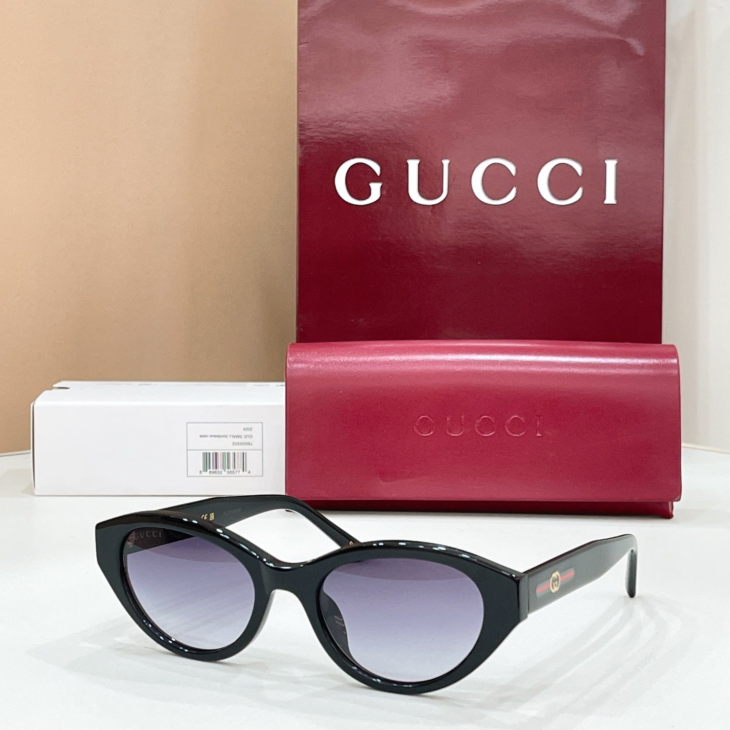 Black sunglasses with dark lenses, Gucci logo on temples, glossy frame finish.
