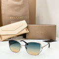 Gold-tone sunglasses with dark blue gradient lenses and thin metal frame