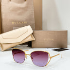 Gold-tone sunglasses with deep purple lenses and slim metal frame