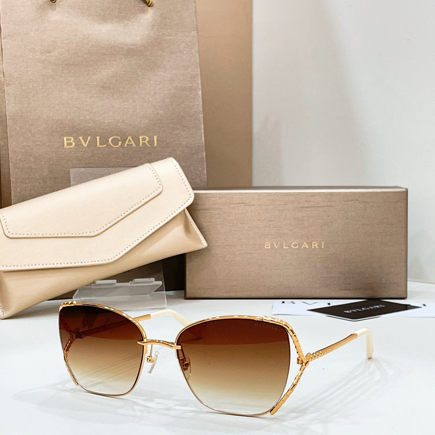 Gold-tone sunglasses with warm brown lenses and thin metal frame