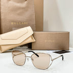 Silver-tone sunglasses with light beige tint lenses and thin metal frame