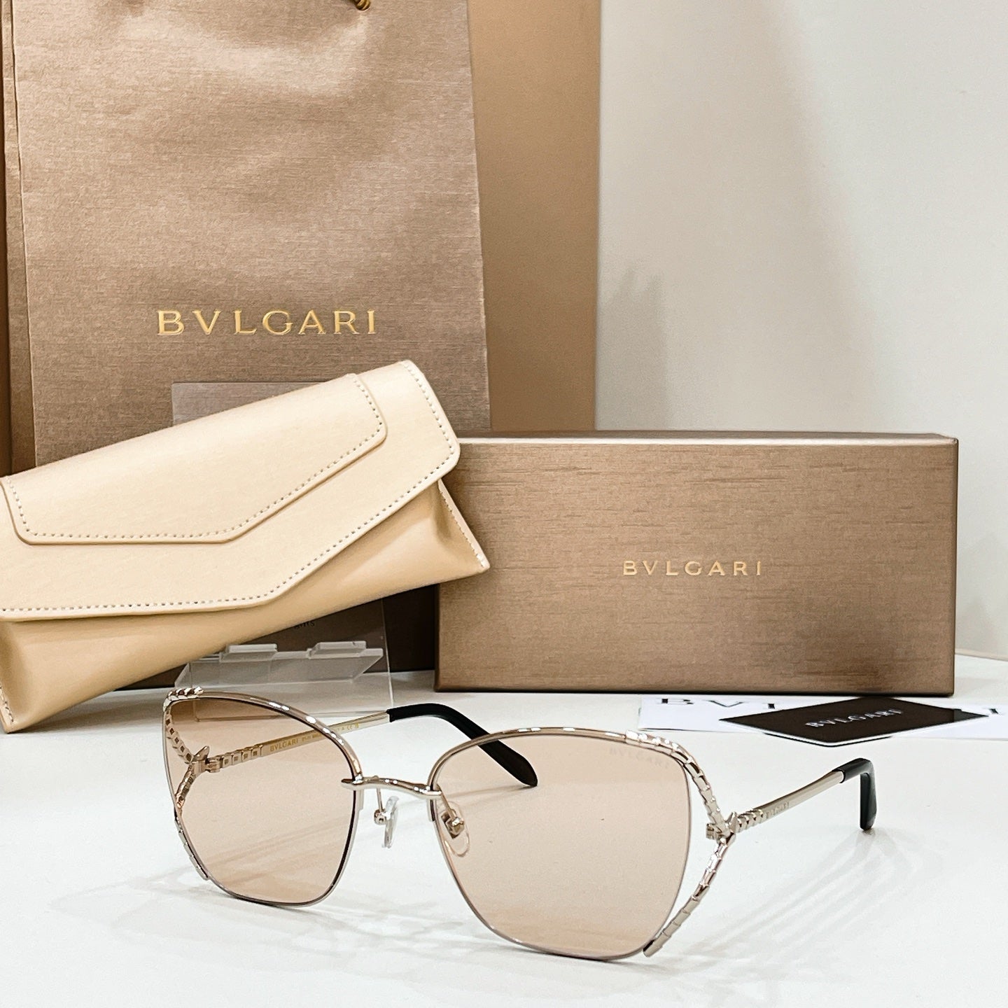 Silver-tone sunglasses with light beige tint lenses and thin metal frame