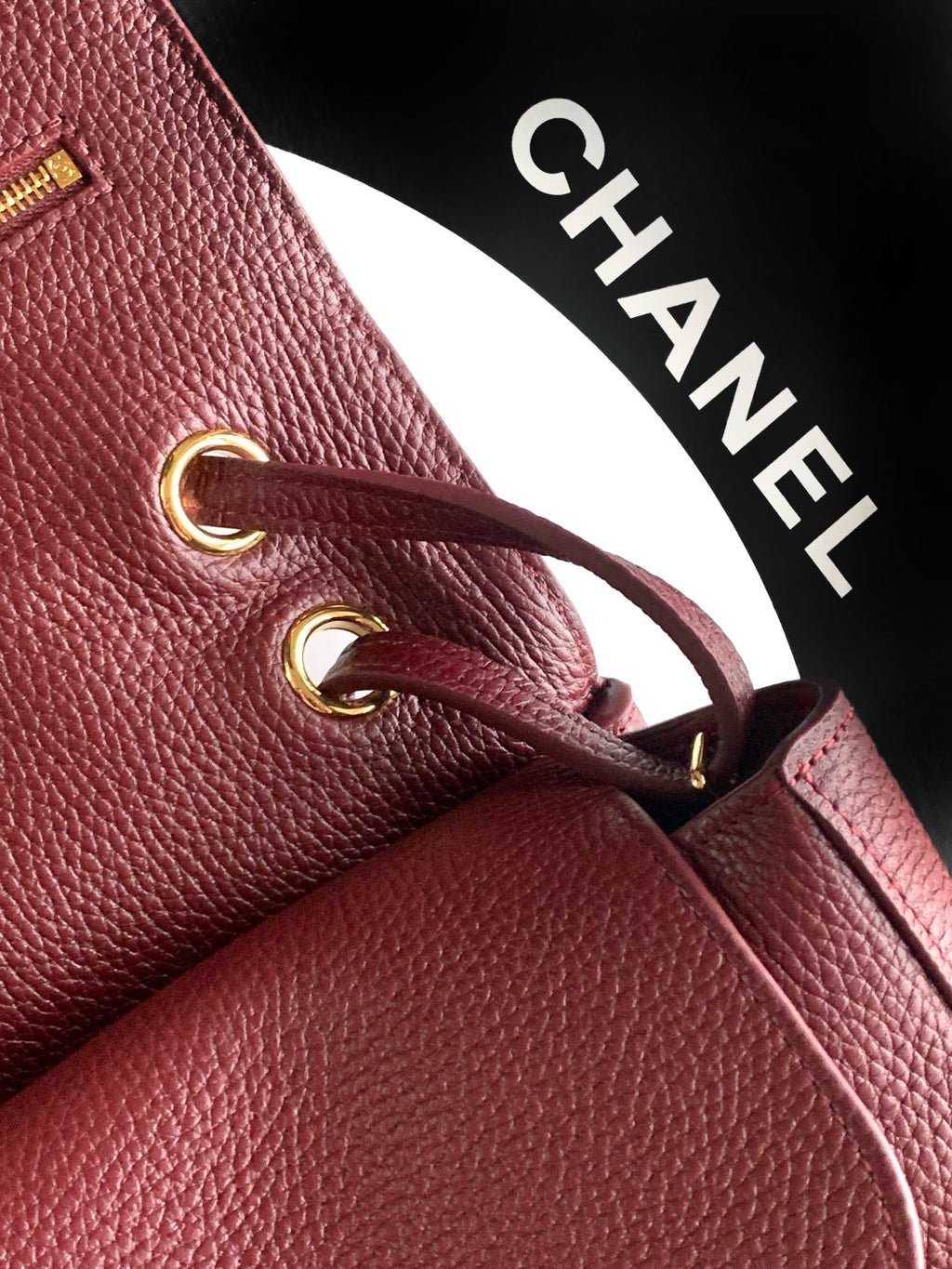 Chanel burgundy leather bag with gold-tone ring detail and top zipper