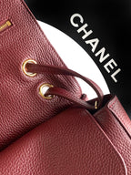 Chanel burgundy leather bag with gold-tone ring detail and top zipper
