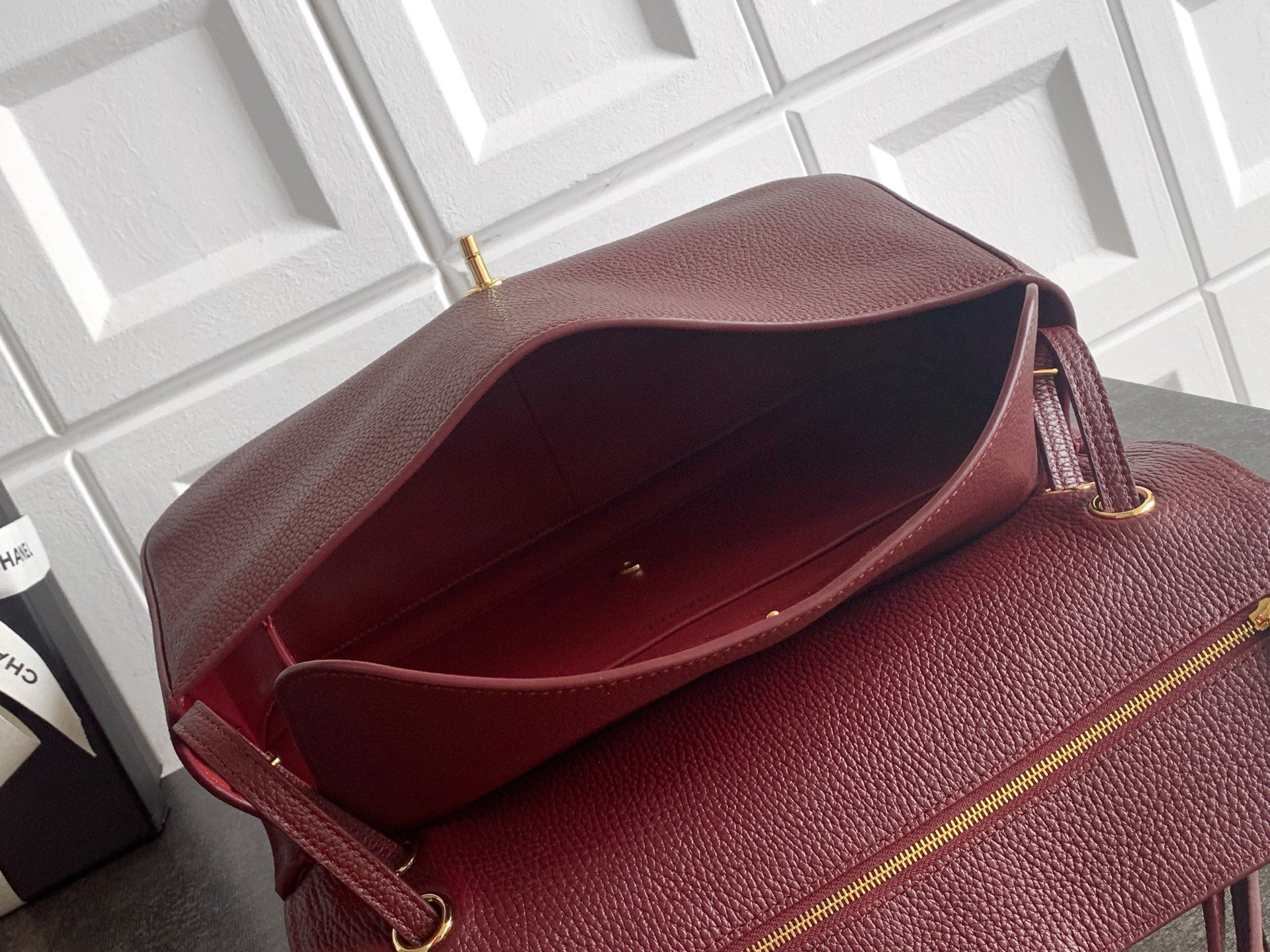 Chanel burgundy textured leather bag open, showing interior lining