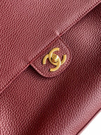 Burgundy textured leather flap bag with gold-tone Chanel CC emblem
