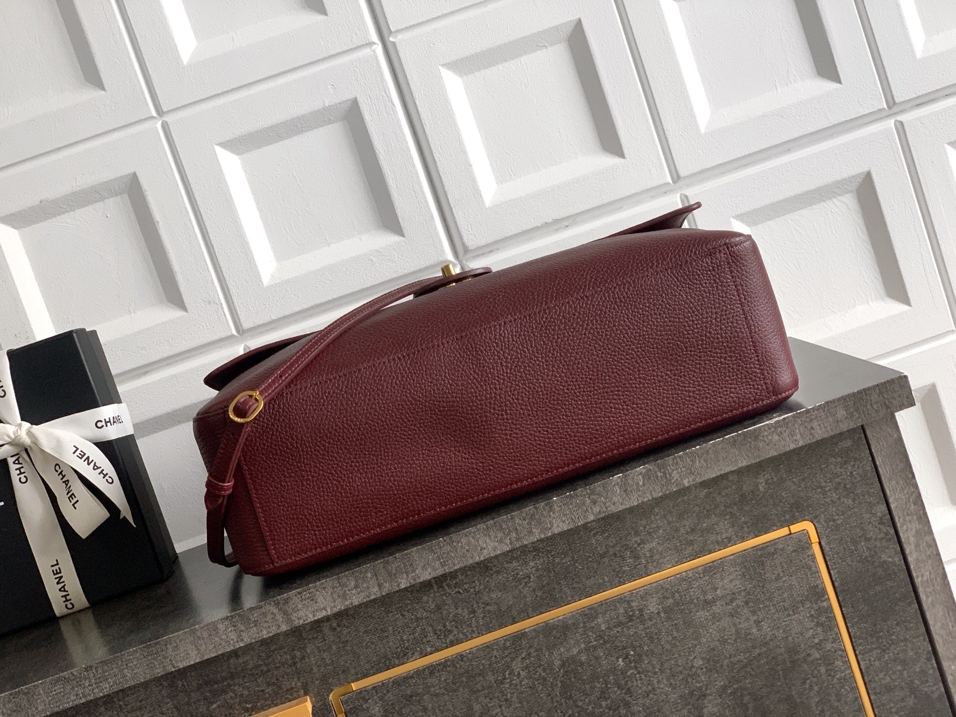 Burgundy leather shoulder bag with flap and gold-tone hardware