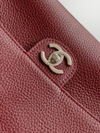 Burgundy leather Chanel bag with textured finish and gold-tone CC logo detail.
