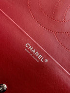 Burgundy Chanel bag with CHANEL and MADE IN FRANCE stamp on leather.