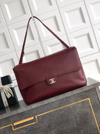 Chanel bag in textured maroon leather with flap and silver-tone logo on front