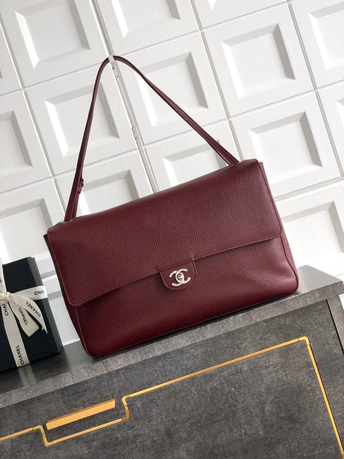 Chanel bag in textured maroon leather with flap and silver-tone logo on front