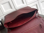 Chanel bag open view in textured maroon leather with zipper top and interior lining