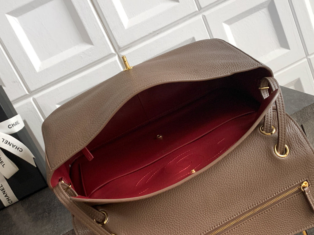 Chanel bag interior view with red lining and gold-tone hardware at top edge