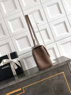 Chanel tote bag in taupe leather with double top handles and structured shape