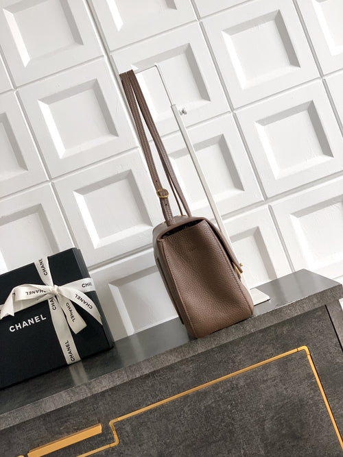 Chanel tote bag in taupe leather with double top handles and structured shape