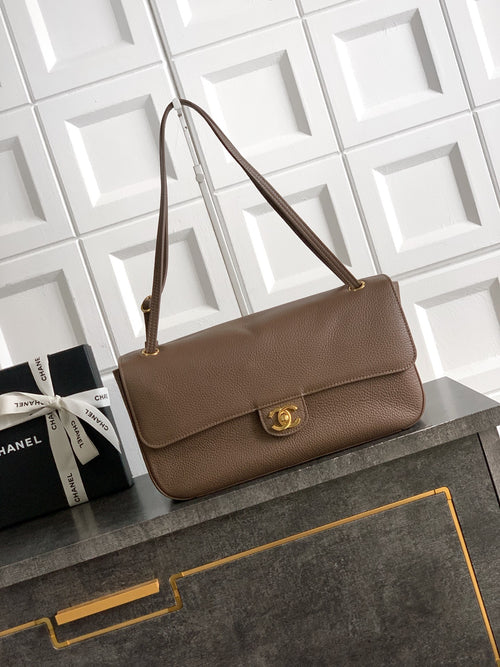 Chanel shoulder bag in taupe leather with gold logo clasp and flap front