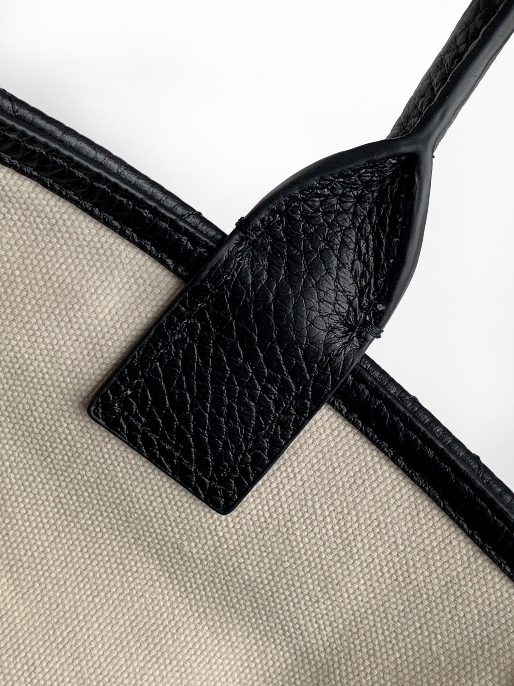 Black leather and cream strap connector with buckle and loop detail