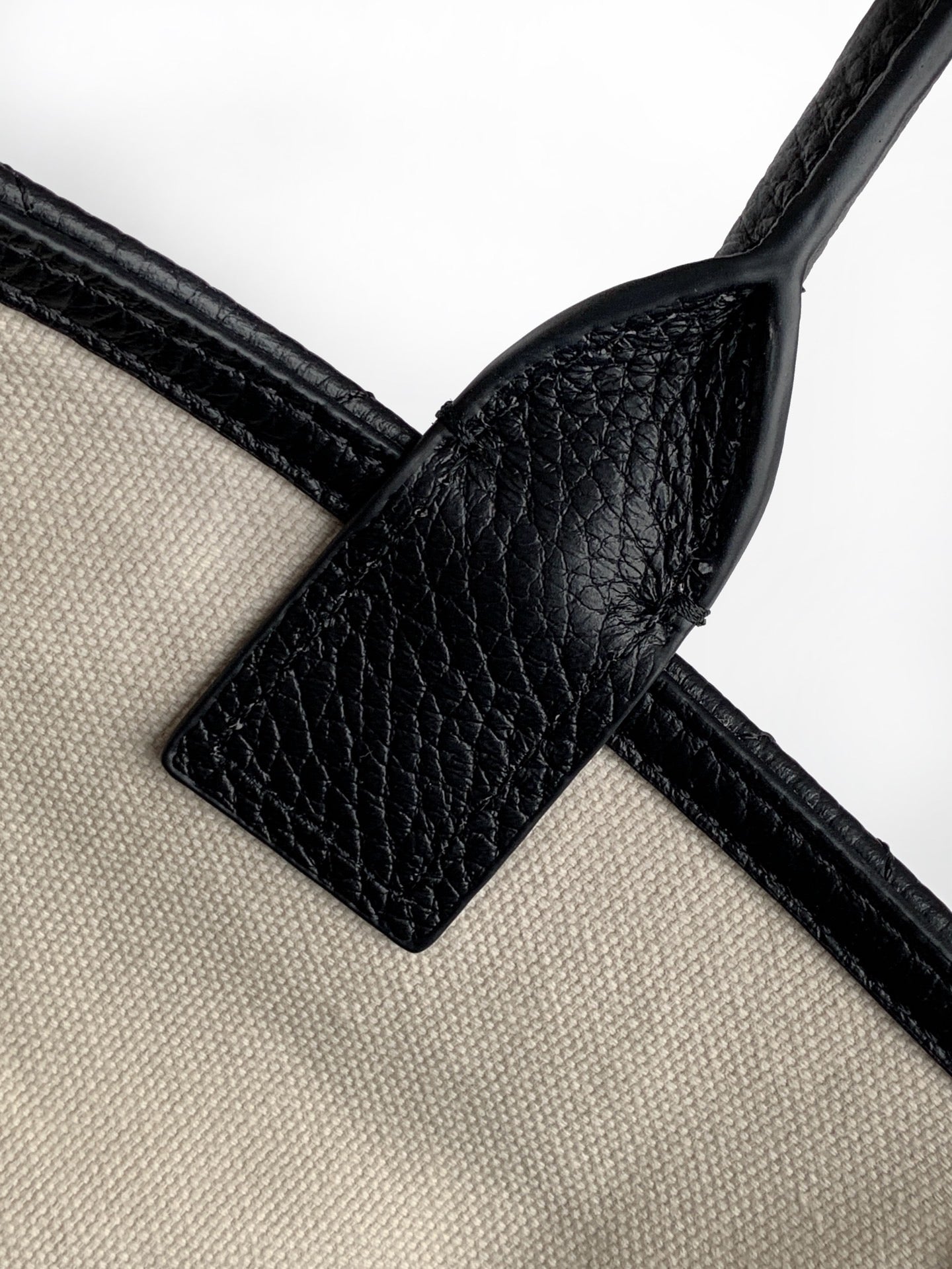 Black leather and cream strap connector with buckle and loop detail
