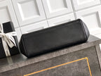 Black Chanel structured handbag with pebble-grain leather and rounded flap