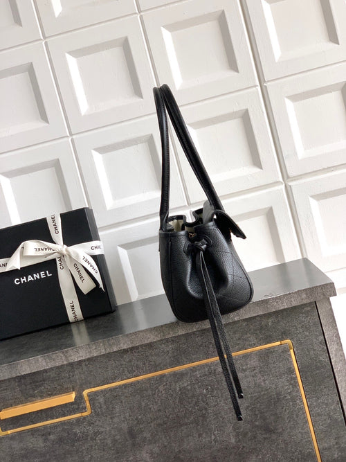 Black Chanel handbag with long strap and side flap, front-angle view