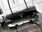 Black Chanel handbag open view with zip pocket and crossbody strap