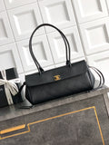 Black Chanel top-handle bag with gold logo plate on the front