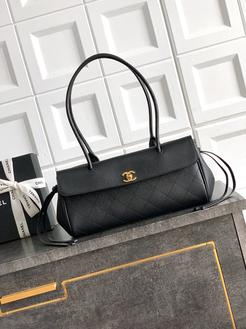 Black Chanel top-handle bag with gold logo plate on the front